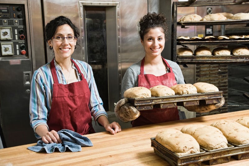 female-bakers-working-at-a-bakery-with-loaves-of-b-2023-11-27-04-52-02-utc